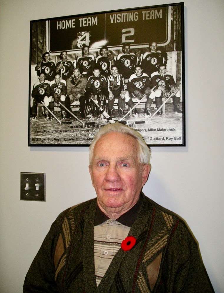 Billy Bessent with his Red Devils photo on the wall of the Legends Lounge at the Coke Centre. Photo by Stan Neufeld