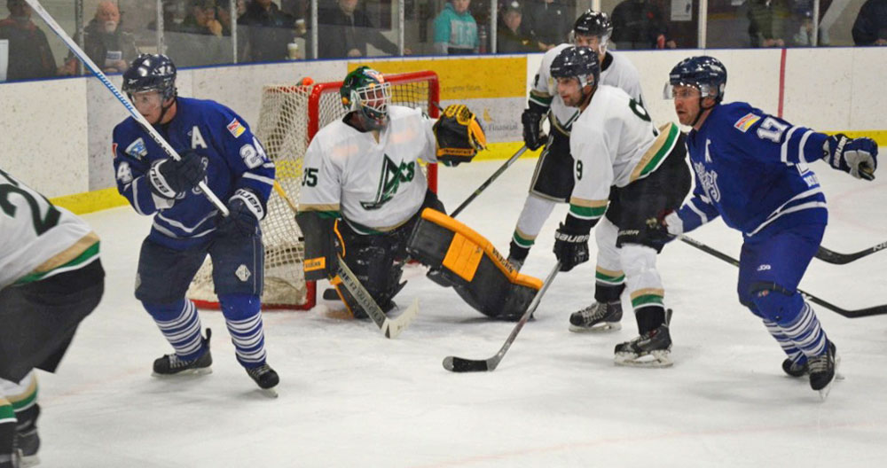 Goaltender Dave Larson snags this shot. Photo by Stan Neufeld
