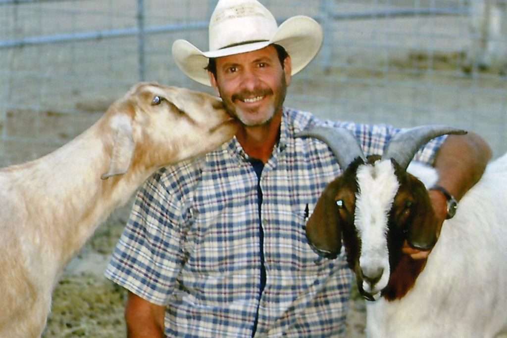 Clint and his goats. Photo courtesy of the Malarchuk family